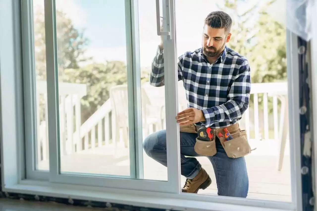 A home maintenance professional checking an exterior door